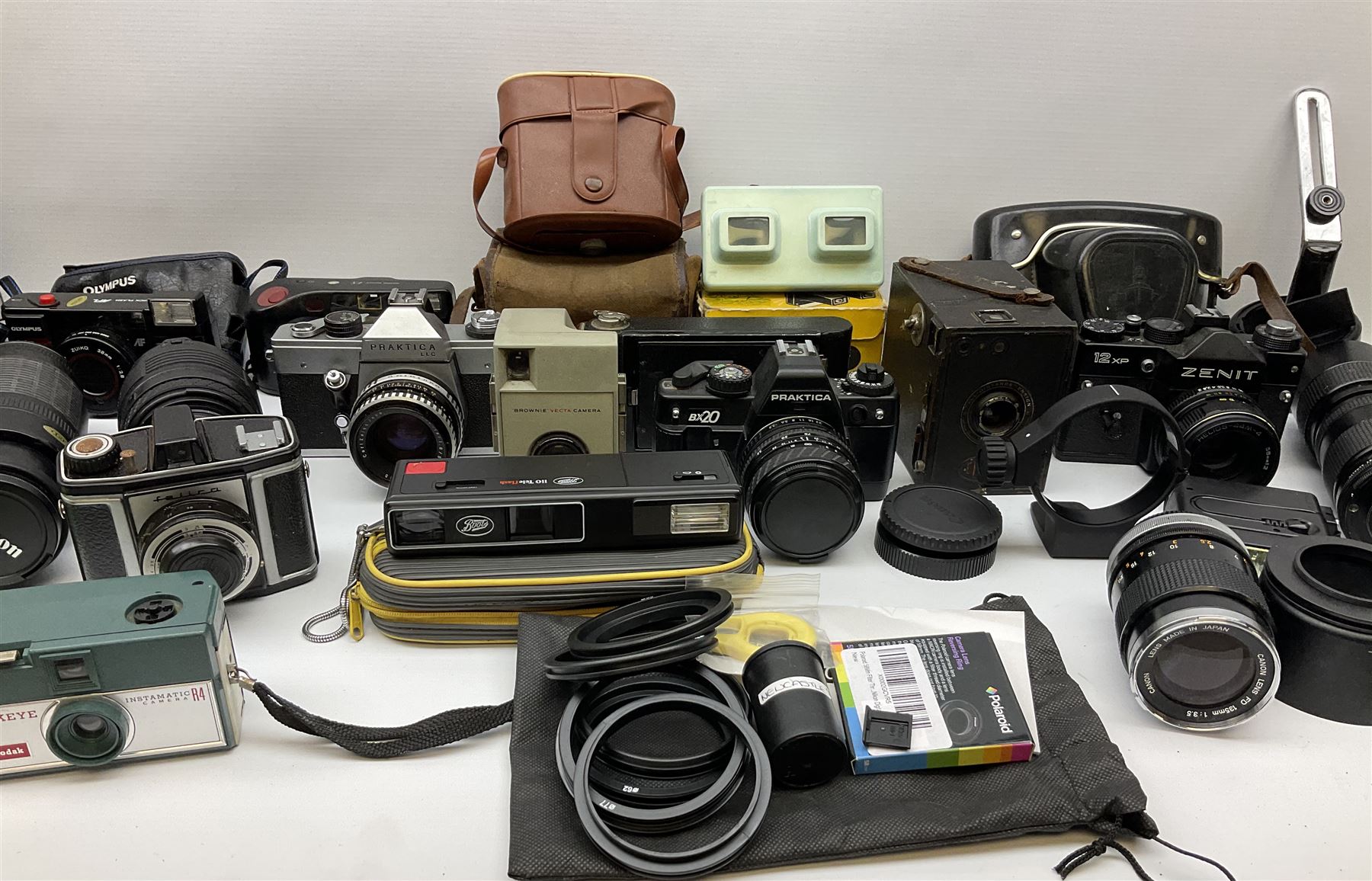 Vintage and later cameras, lenses, accessories and darkroom equipment including Zenit 12XP camera, Praktica BX20 camera fitted with 'Sigma Zoom Master 1:3.5-4.5 f=35-70mm' lens, Praktica LLC camera fitted with 'Carl Zeiss Jena Pancolar 1.8/50' lens, Canon Zoom Lens 'EF 100-300mm 1:5.6', various Jessop and other makers darkroom items including safelight (Red), universal duo tank, multi-mask enlarging easel etc, in three boxes