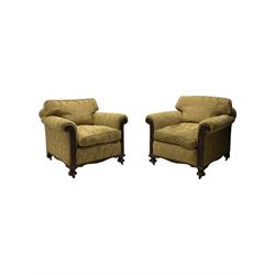 Early 20th century mahogany framed three-piece lounge suite - three-seat camelback sofa (W203cm, D105cm); pair of matching armchairs (W95cm, D96cm); upholstered in neutral foliate pattern fabric, carved with trailing leafy branches, ball and claw carved feet with brass castors 