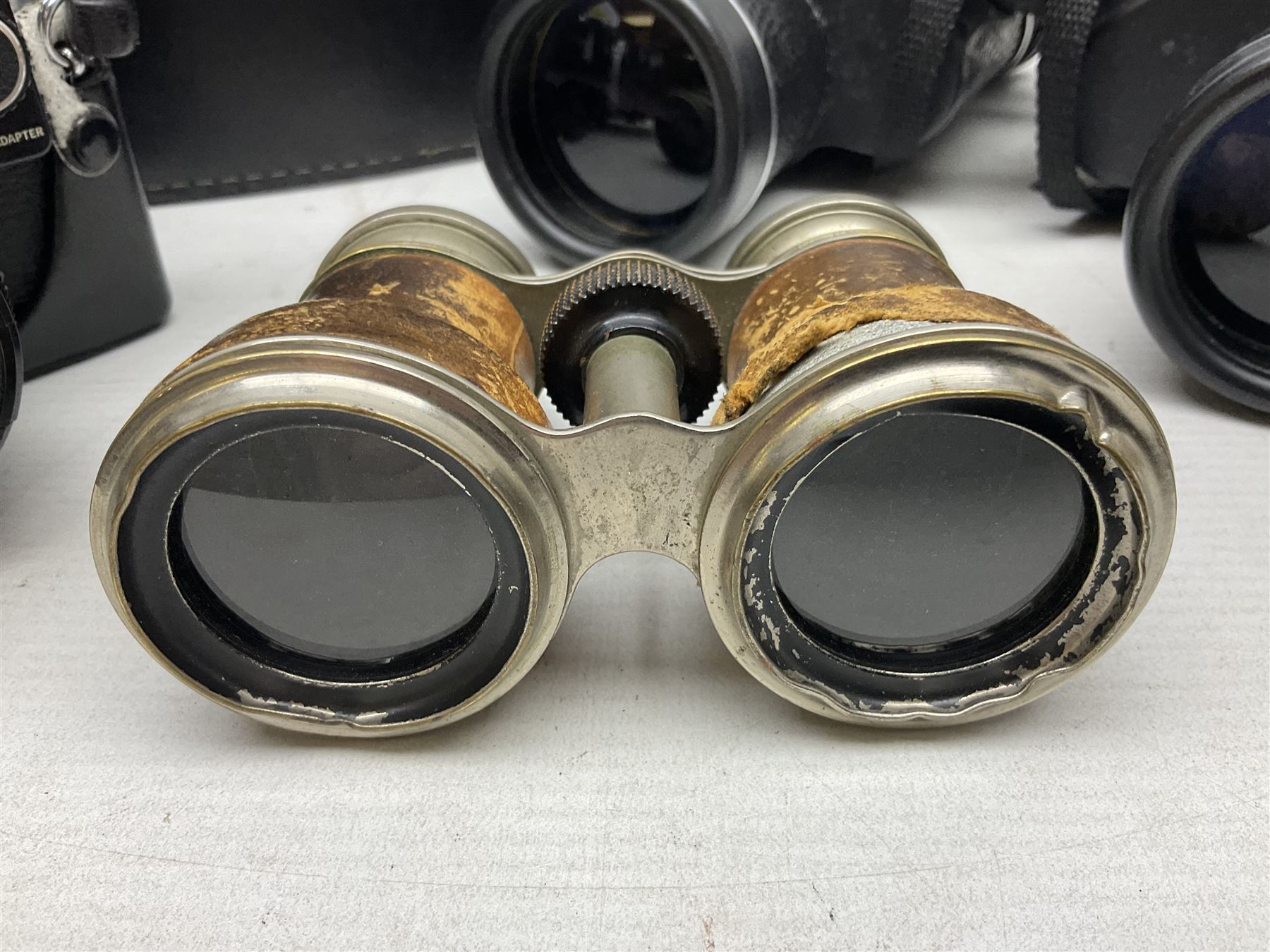 Olympus OM10 35mm camera, cased; pair of USSR 7 x 50 binoculars; cased; and pair of Le Jockey Club Paris binoculars