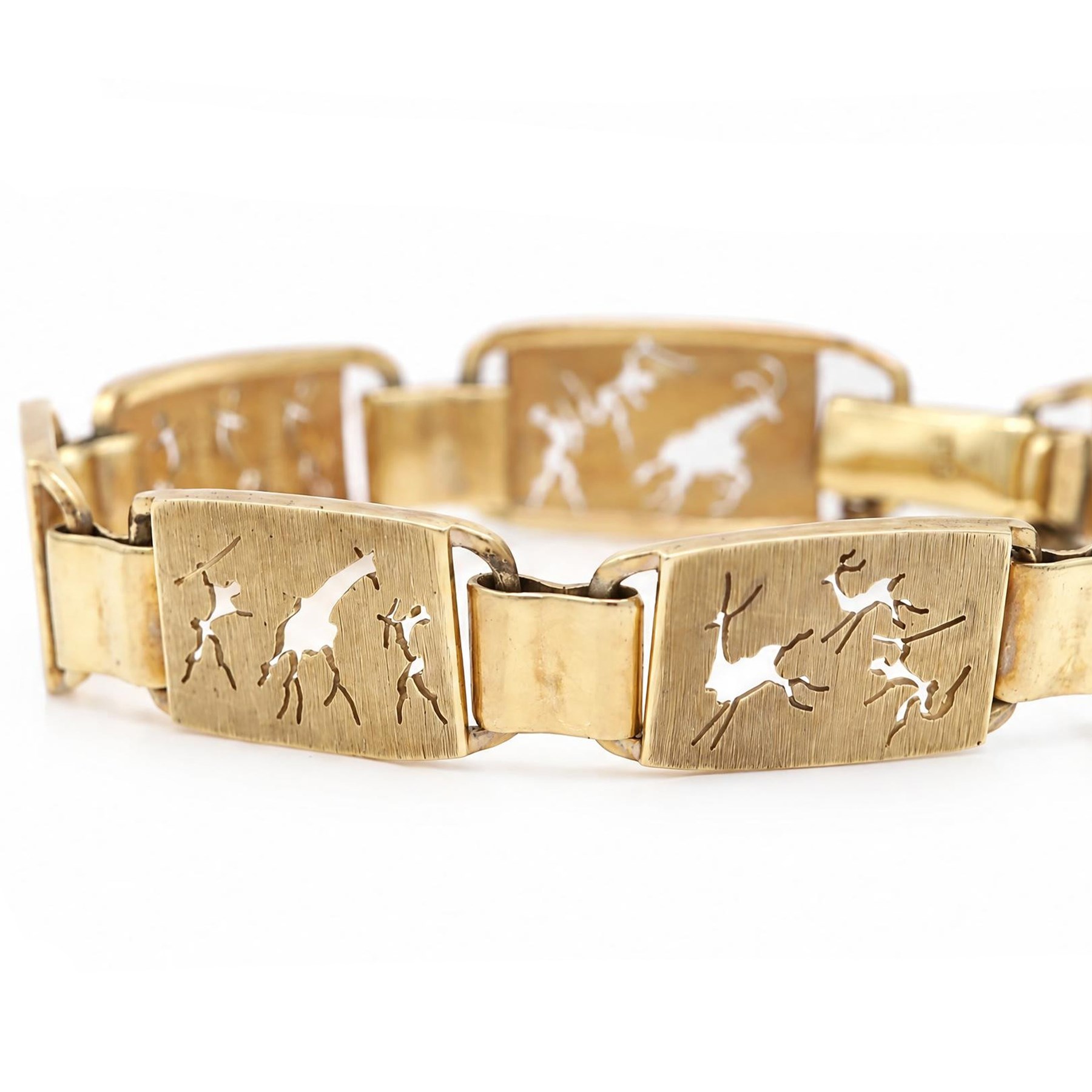 Gold seven panel bracelet, each with pierced design hunting scene decoration, stamped 9ct