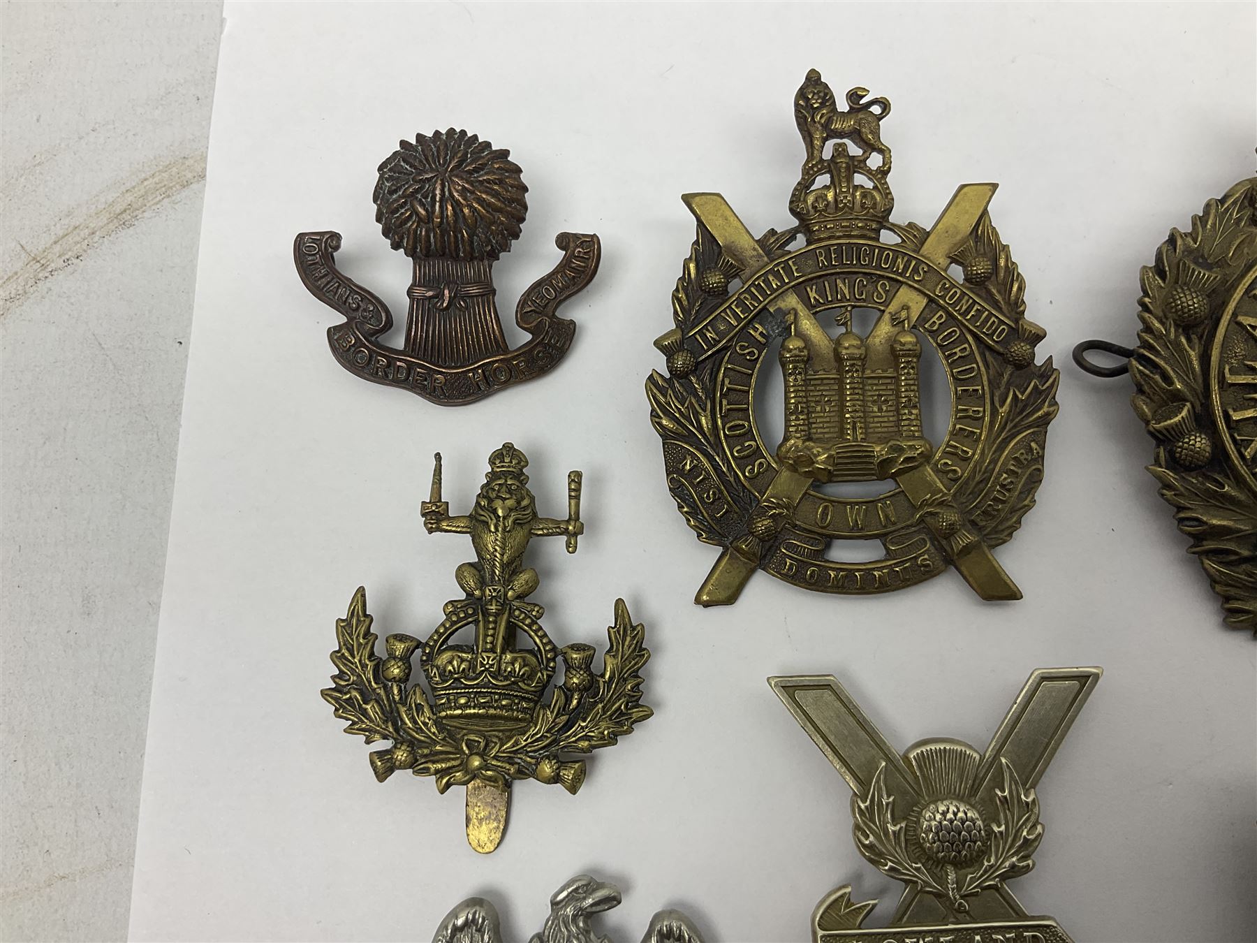 Fifteen Scottish Glengarry and other metal military badges including Argyll & Sutherland, Royal Glasgow Yeomanry, Cameronians, Lanarkshire Yeomanry, Kings Scottish Own Borderers, Highland Light Infantry, Border Regiment, Lowland Regiment, Lothians & Border Horse Yeomanry, Ayrshire Earl of Carricks Own Yeomanry etc