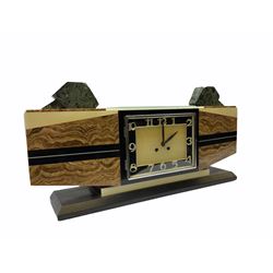 1930’s French Art Deco mantle clock in distinctive vein cut brown marble with inlaid cream and black marble, rectangular dial in contrasting black and cream marble with distinct offset chrome Arabic numerals, baton hands and chrome bezel, two train eight-day Parisian countwheel movement striking the hours and half-hours on a bell, Swiss in-line lever platform escapement, steel balance with timing screws,
the rectangular case raised on a black and cream marble plinth with additions of oblique green granite to the top.   
movement stamped “Marti & Co” 
