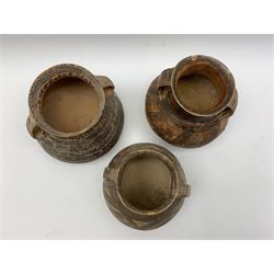 Three Chinese Neolithic pottery vessels, each with twin loop handles to the shoulder and painted geometric banded decoration to the body, all bearing labels for Eskenazi London, tallest H14cm