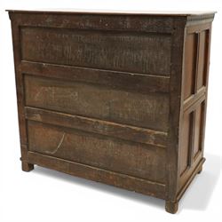 18th century oak chest of drawers, rectangular plank top with chip carved frieze, fitted with three long geometrically panelled drawers with applied mouldings, later brass drop handles, on stile supports, panelled sides and boarded back