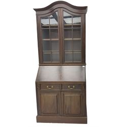 Late 19th century mahogany bureau bookcase, the shaped and moulded pediment over two astragal glazed doors, fall front enclosing fitted interior, two drawers and double cupboard below, on skirted base