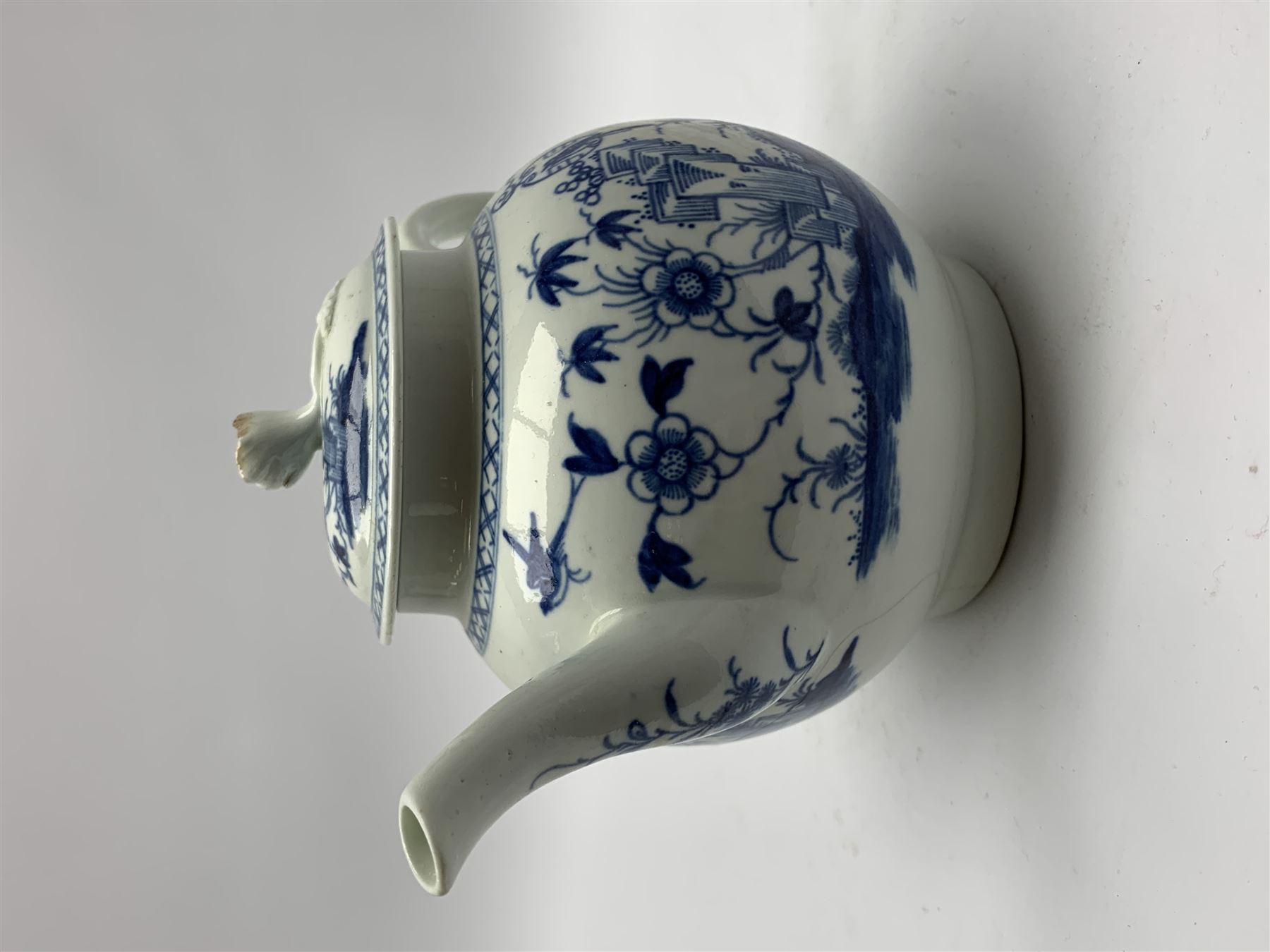 18th Century Worcester teapot, circa 1765-70, decorated in the Bird in the ring pattern, the cover with bud finial, with crescent mark beneath, H13cm, together with a Worcester coffee cup decorated in the same pattern, with crescent mark beneath, H6.5cm