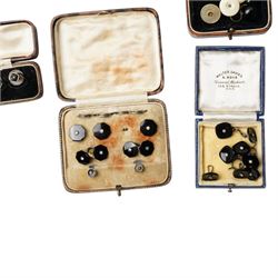 Early 20th century dress sets including onyx and paste examples, some stamped 935, paste set buckles and buttons, faux turquoise jabot pin, in the style of Bernard Instone, silver cufflinks etc, housed in an early 20th century red leather jewellery box
