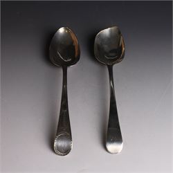 George II silver Old English pattern table spoon, with engraved initial W to terminal, hallmarked Thomas Northcote, London, probably 1758 date mark worn, together with a George III Old English pattern table spoon with bright cut decoration and engraved initials, hallmarked London 1783, makers mark TE probably for Thomas Evans