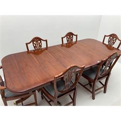 Yew wood twin pedestal extending dining table, shaped supports and brass castors (W216cm, D100cm, H77cm) and six (4+2) chairs, shaped back and upholstered in patterned fabric raised on fluted supports (W52cm)