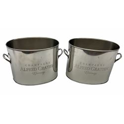 A pair of 20th century nickel plated champagne coolers inscribed Alfred Gratien Champagne, each flanked by twin loop handles, height 18cm