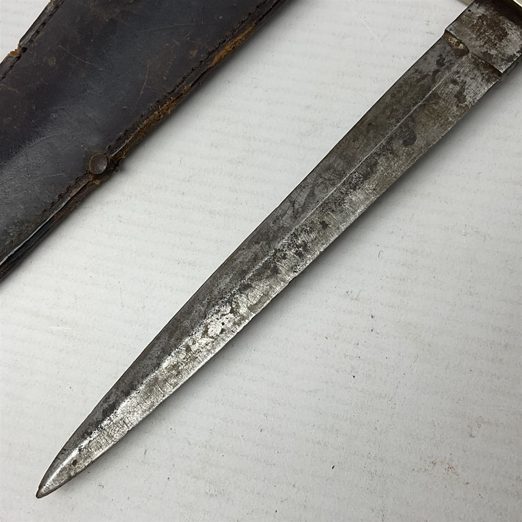  British Private Purchase fighting knife by William Rodgers, Sheffield, the 15cm double edge steel blade with raised medial ridge, stamped on one side of the ricasso WILLIAM RODGERS I CUT MY WAY, the opposing side marked MADE IN SHEFFIELD, ENGLAND, with aluminium crossguard and pommel, stacked leather washers grip and leather scabbard L27.5cm overall; and a crudely made short sword with 32.5cm single edged blade and steel knucklebow hilt with hardwood grip; in cane bound wooden scabbard L45cm overall (2)