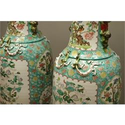  Pair of large 20th century Canton polychrome floor vases, cylindrical bodies decorated with exotic birds amidst foliage in reserve panels on a green ground, flared neck, H122cm (2)  