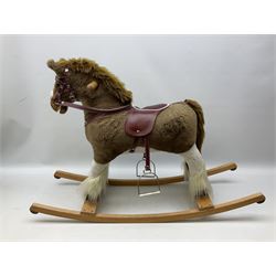 Modern plush covered rocking horse with inset eyes, simulated leather bridle and saddle with metal stirrups, on curving wooden rockers L94cm H64cm
