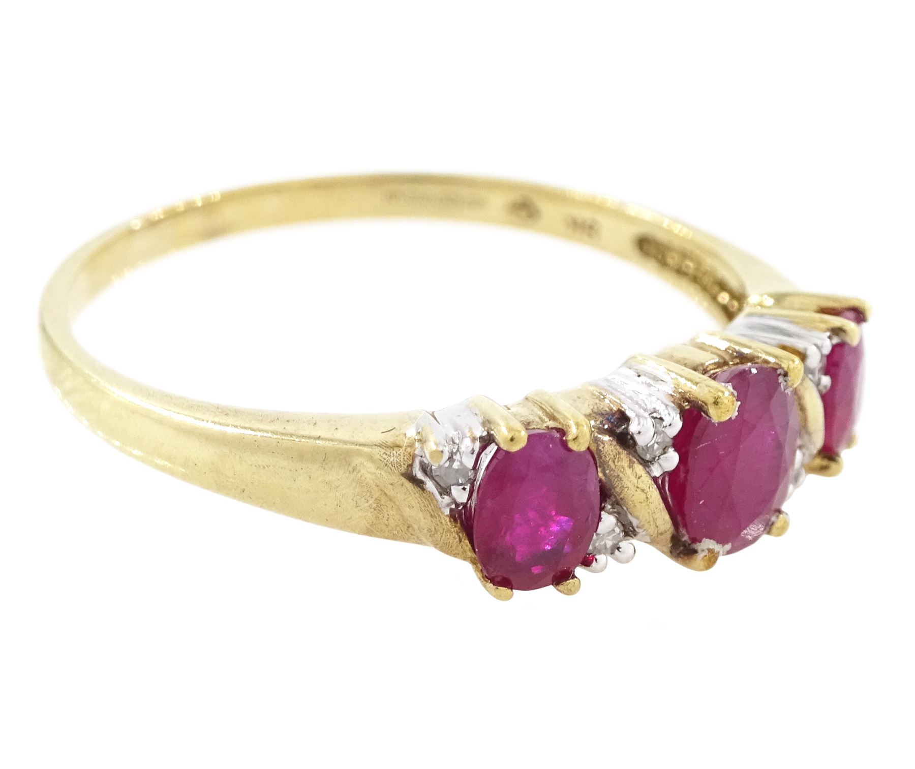 9ct gold ruby and diamond ring, three oval cut rubies spaced by six accent diamonds, stamped 9k