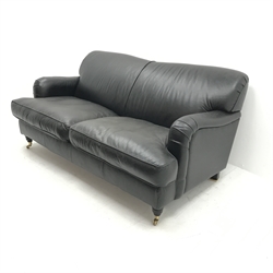 Three seat traditional sofa upholstered in black leather, turned supports, W184cm