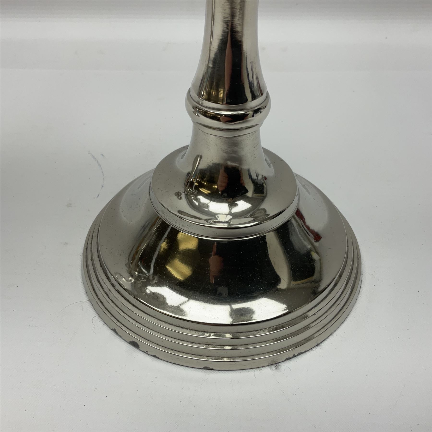 Pair of four branch candelabras, urn-shaped nozzles raised upon scroll branches supported from tapering central stem, with a stepped circular base, H40cm