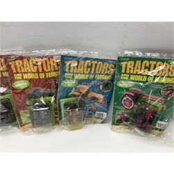 Eighteen issues of Tractors and The World of Farming magazine, together with sixty diecast tractors, all in original packaging, in three boxes 