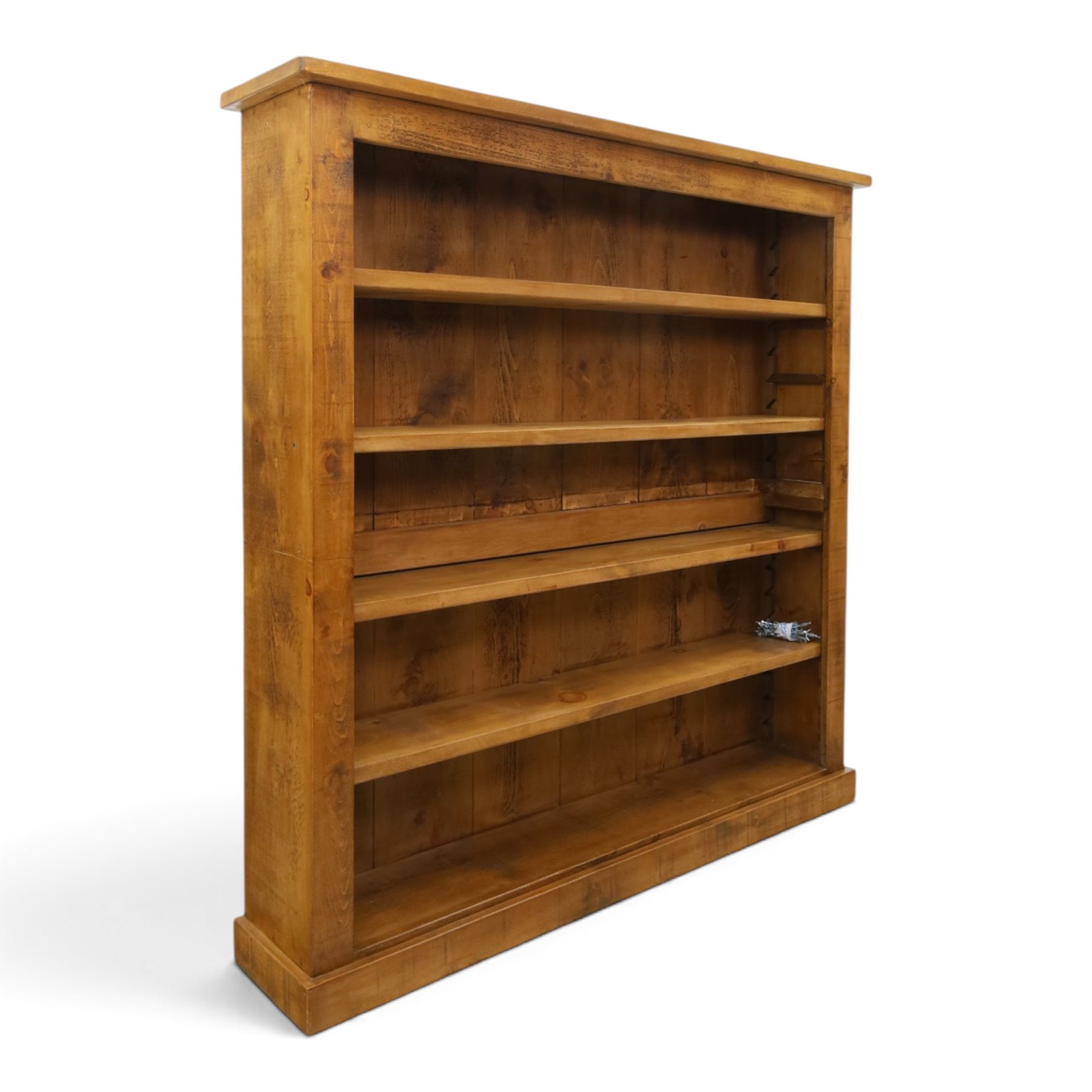 Indigo Furniture - large rustic oak open bookcase, with four adjustable shelves, above a plinth base 