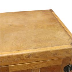 Mouseman - mid-20th century adzed and panelled oak tallboy chest, arcade carved cresting rail over two panelled cupboard doors with wrought iron fittings and latch, enclosing single shelf, over two short and two long drawers with lightly adzed facias and turned knob handles, raised on square supports, relief carved mouse signature, by the workshop of Robert Thompson of Kilburn