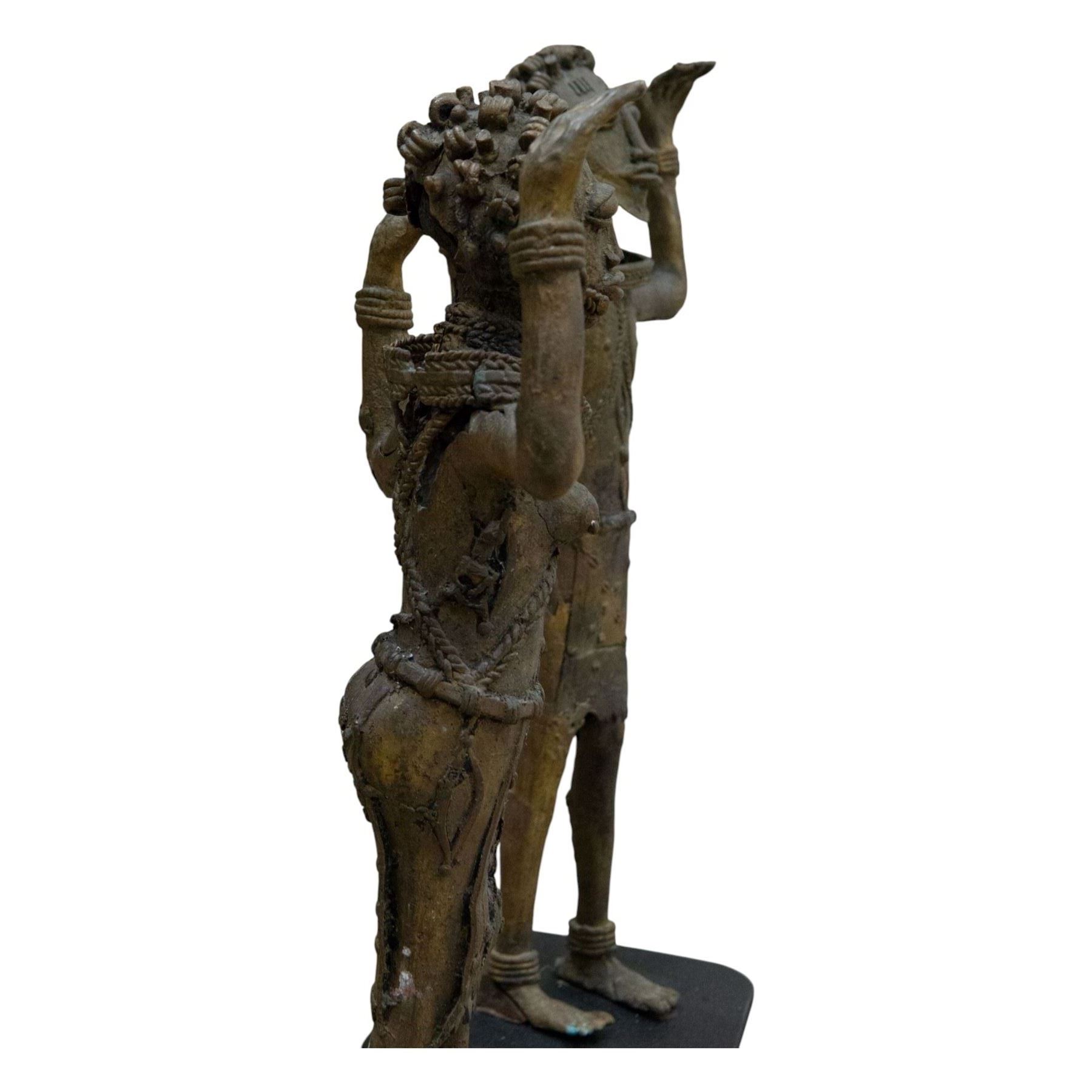 Pair of Benin bronze statures, modelled as a male and female, with armed raised, upon a square base, H76cm