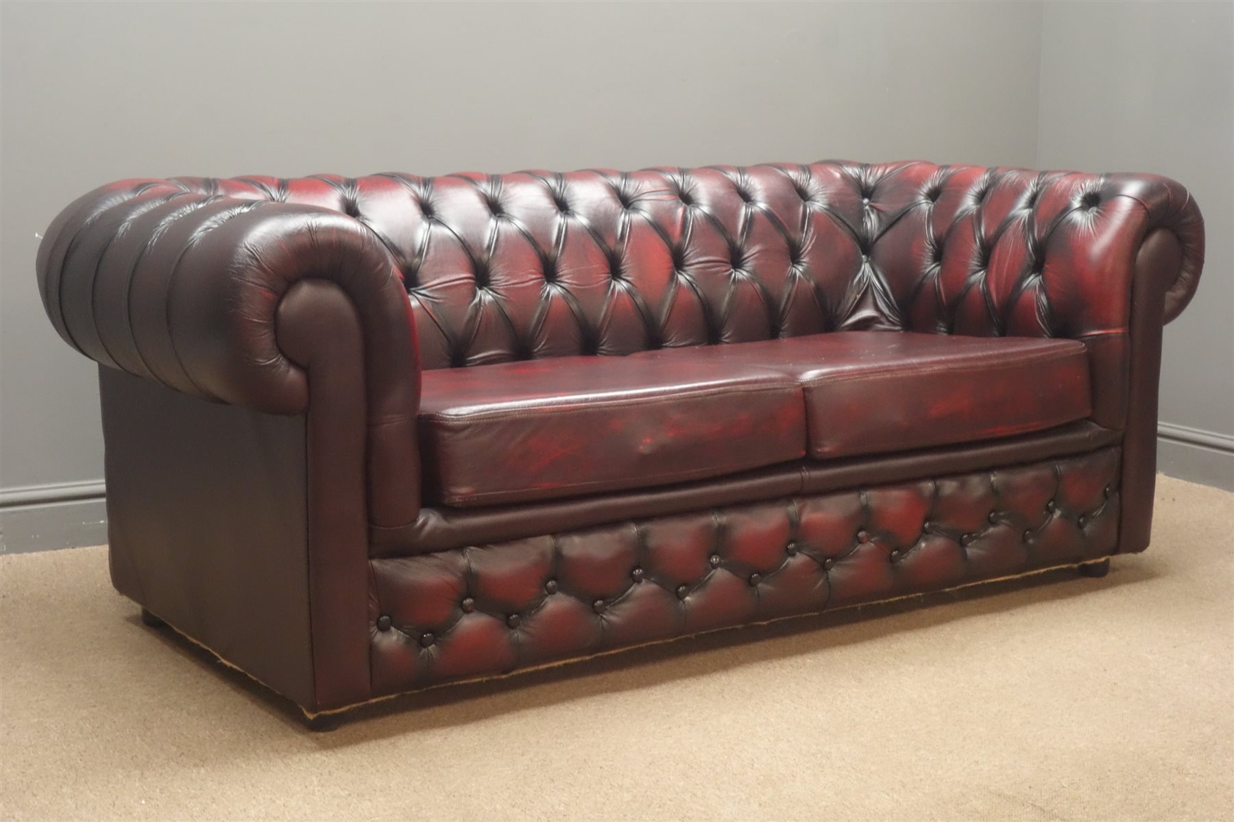 Chesterfield two seat sofa bed upholstered in leather with additional