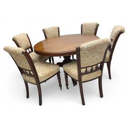 Victorian mahogany centre table, circular top above turned pedestal, terminating on three cabriole legs with scroll feet on porcelain castors, and six scroll carved upholstered dining chairs, with cushion and spindle turned backs, centre table  118x74cm, dining chairs 89x46x50cm