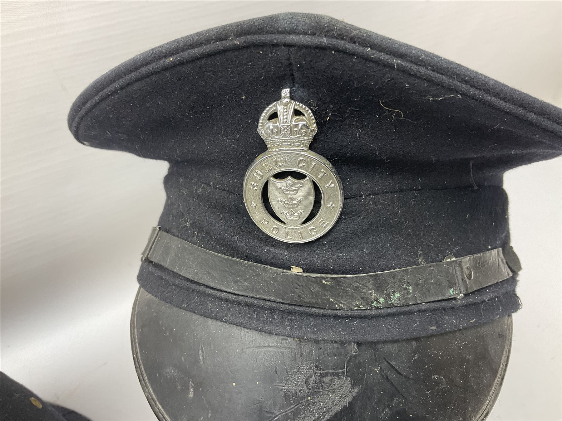 Hull City Police - helmet with king's crown night plate; two further ball-top helmets with Queen's crown plates; and a peaked cap (4)