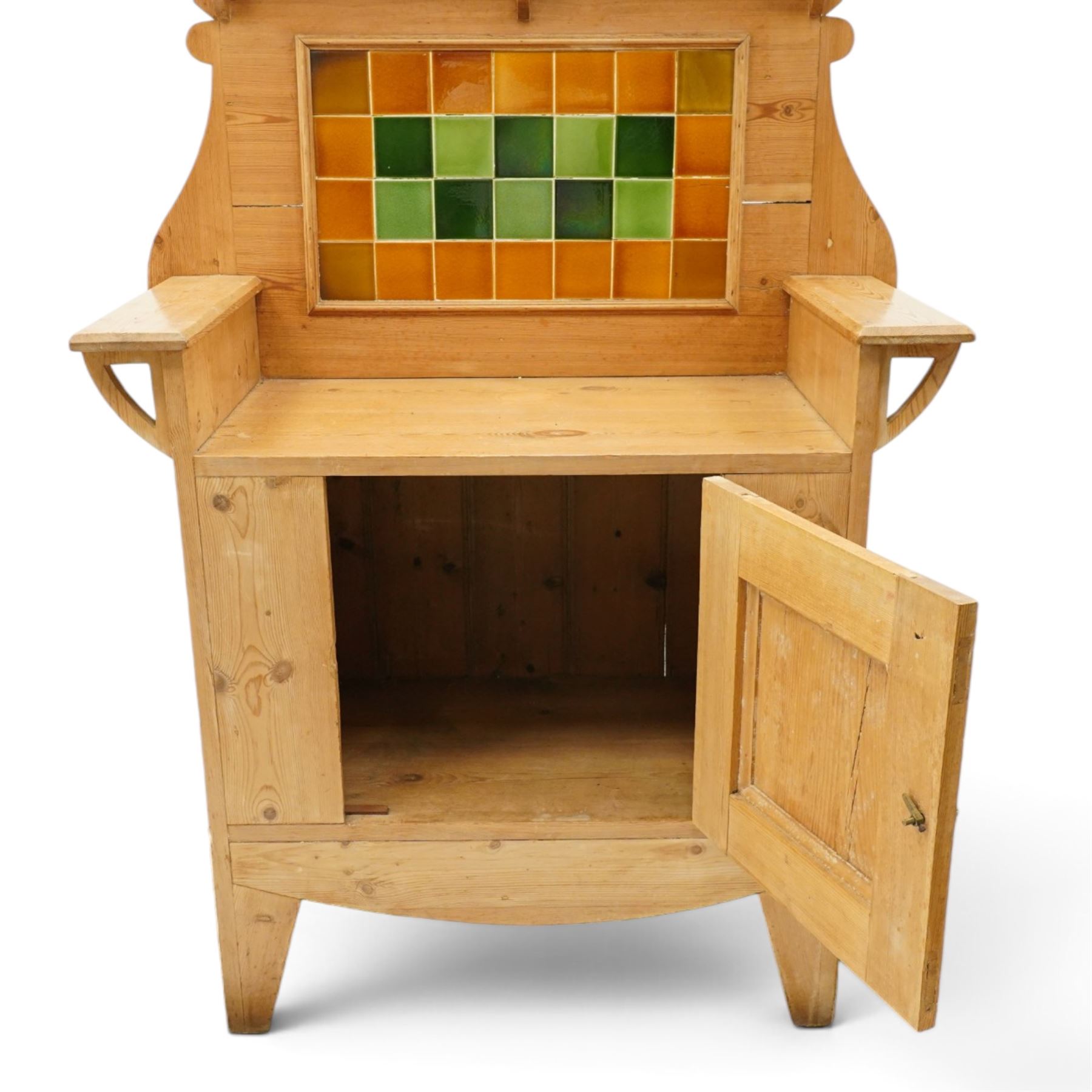 Arts & Crafts pine kitchen cabinet, raised tiled back with projecting shelf and shaped side supports, rectangular work surface above single cupboard door with moulded panel, on square supports