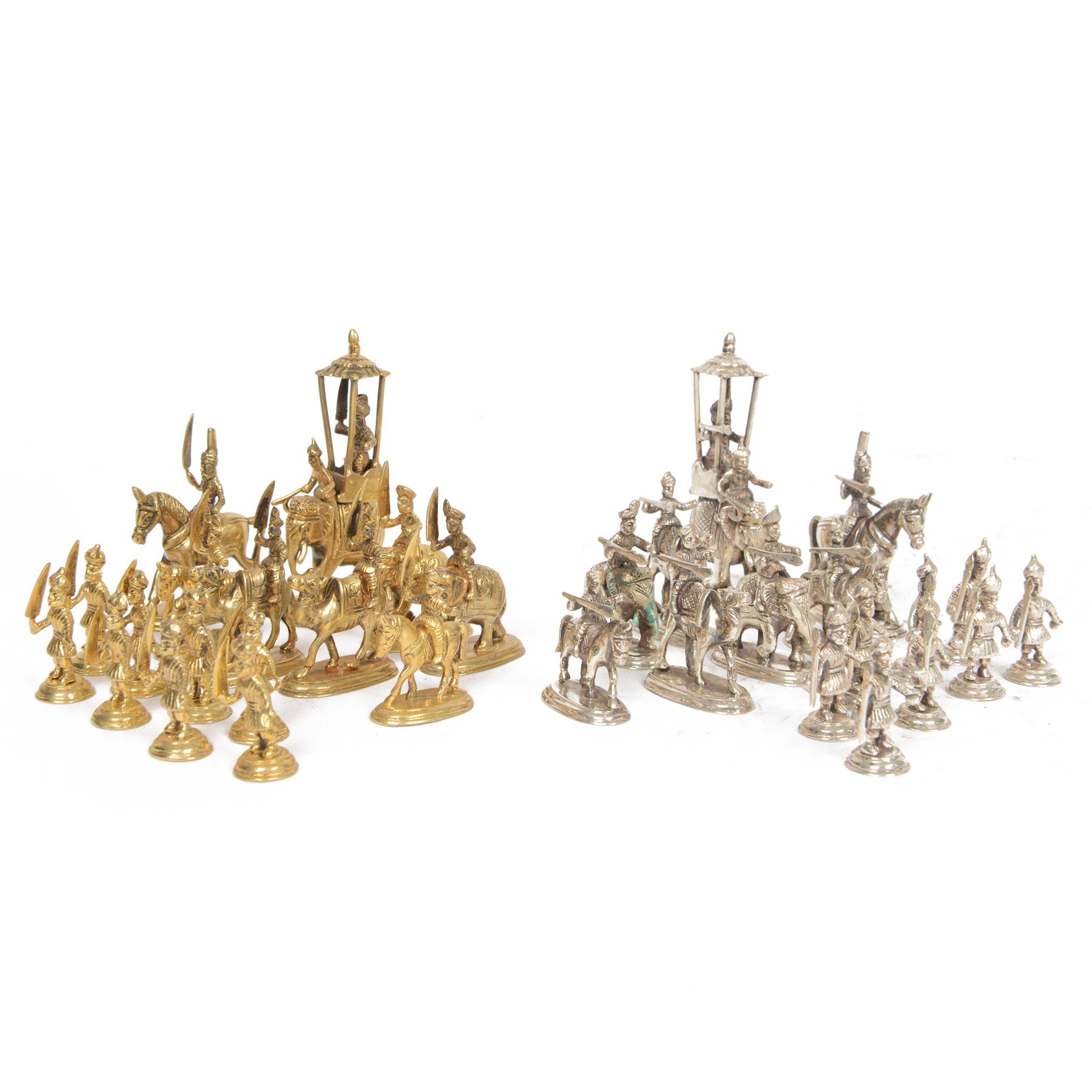19th century Moghul Indian silver and silver gilt chess set, comprising thirty-two pieces, modelled as soldiers mounted upon elephants, camels and horses with the pawns on foot, unmarked, King H10cm