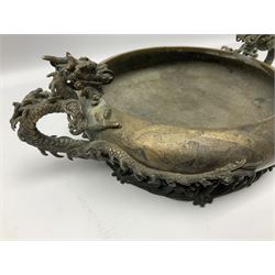 19th century Japanese bronze censer, the compressed body with inverted rim flanked by twin dragon handles, upon a openwork foot modelled as a waves, L29cm
