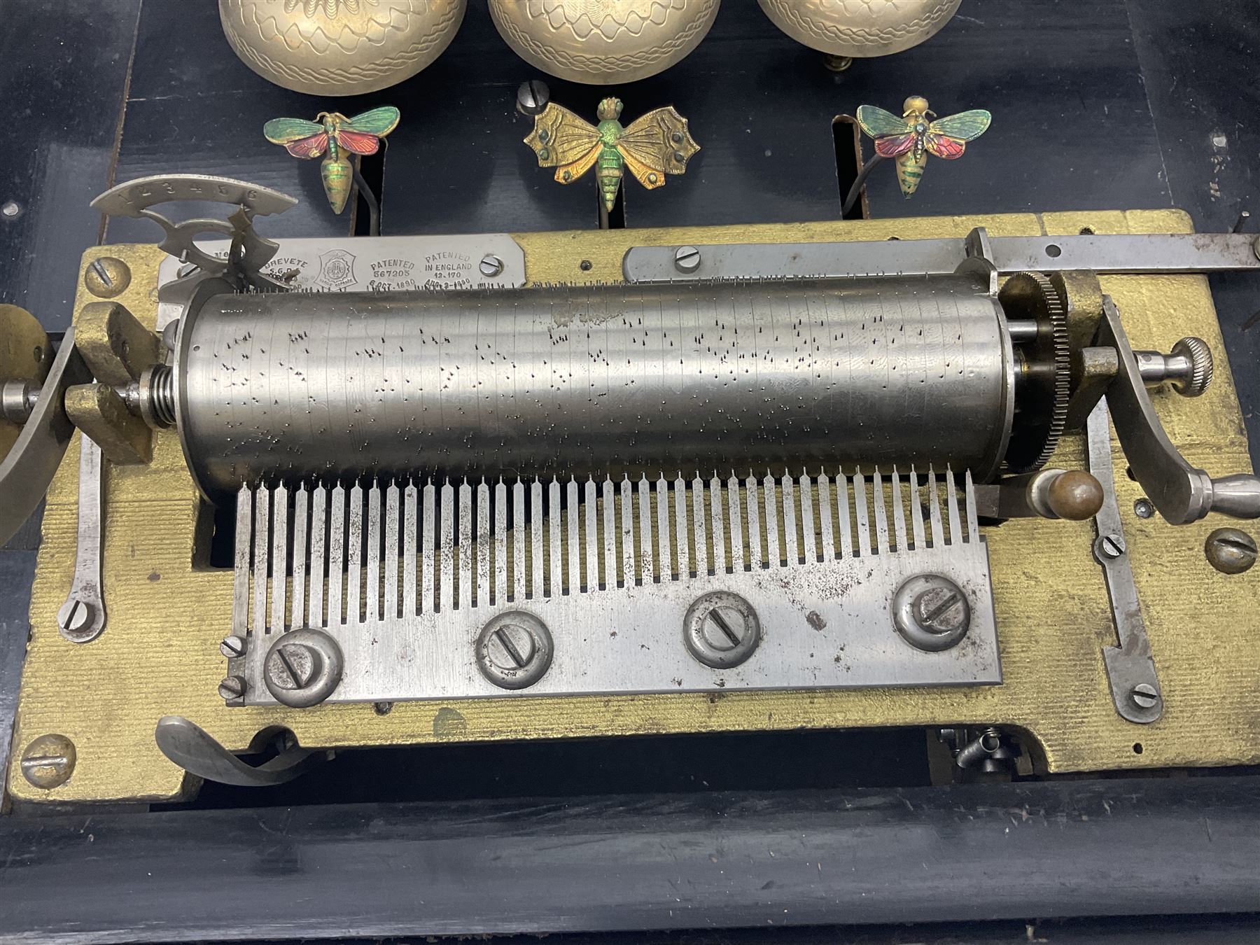 Swiss - 19th-century cylinder music box with three butterfly bells in sight, in a mahogany case with two separately boxed  6” cylinders, glazed viewing lid, 41 tooth comb (one tooth broken) crank key missing, movement untested.