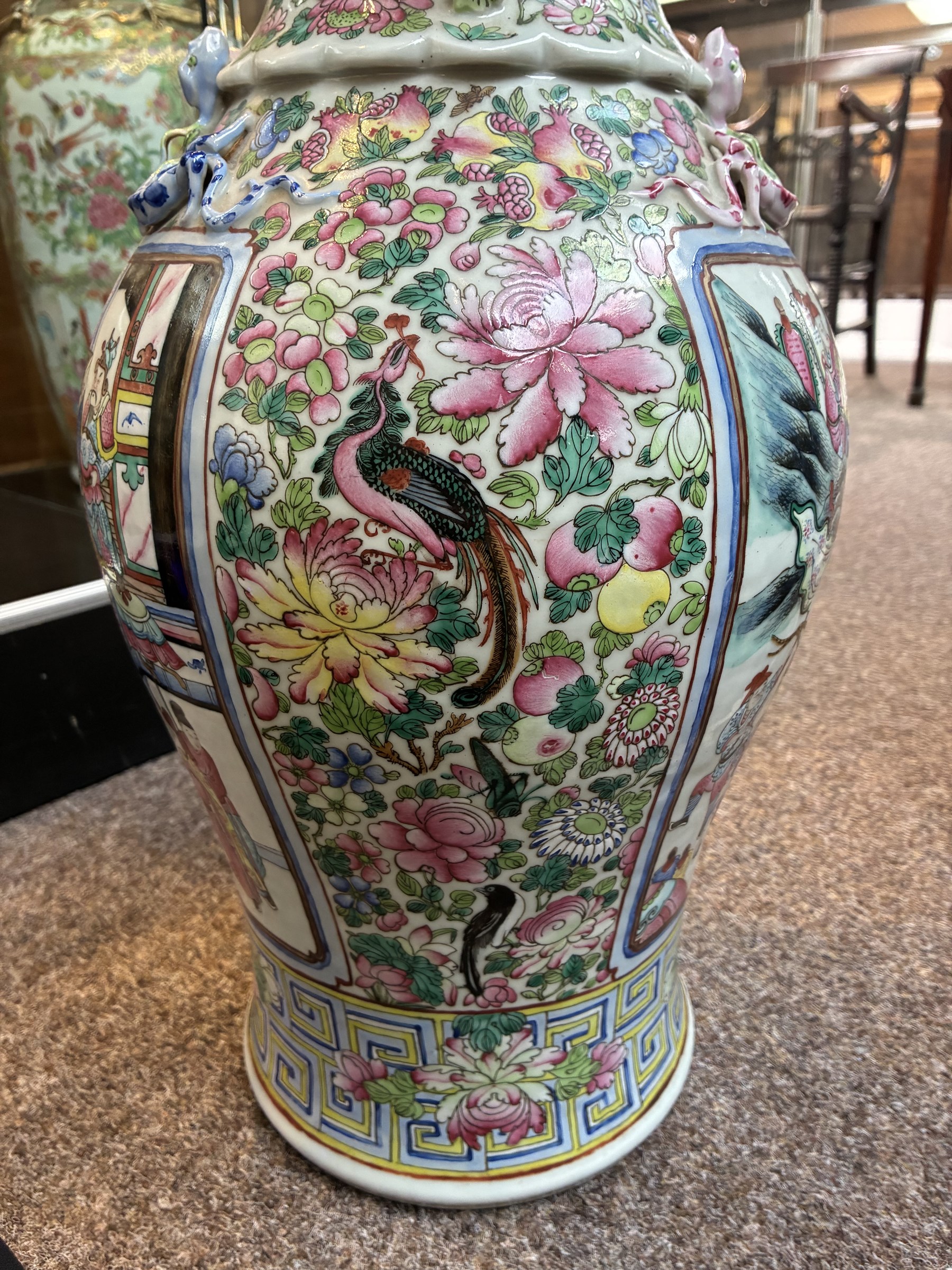 Large pair of 19th century Cantonese famille rose vases, each painted with various courtly scenes, including a display of warriors fighting on horseback before an official and his attendants, double Buddhist lion handles and applied at the shoulders with chilong, the lower band painted with Greek key motif, H58cm (2)