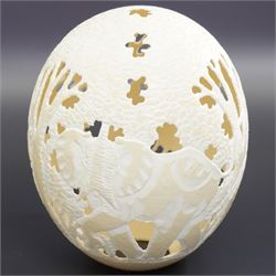 Ostrich egg with pierced decoration, depicting elephants in a forest, H16cm