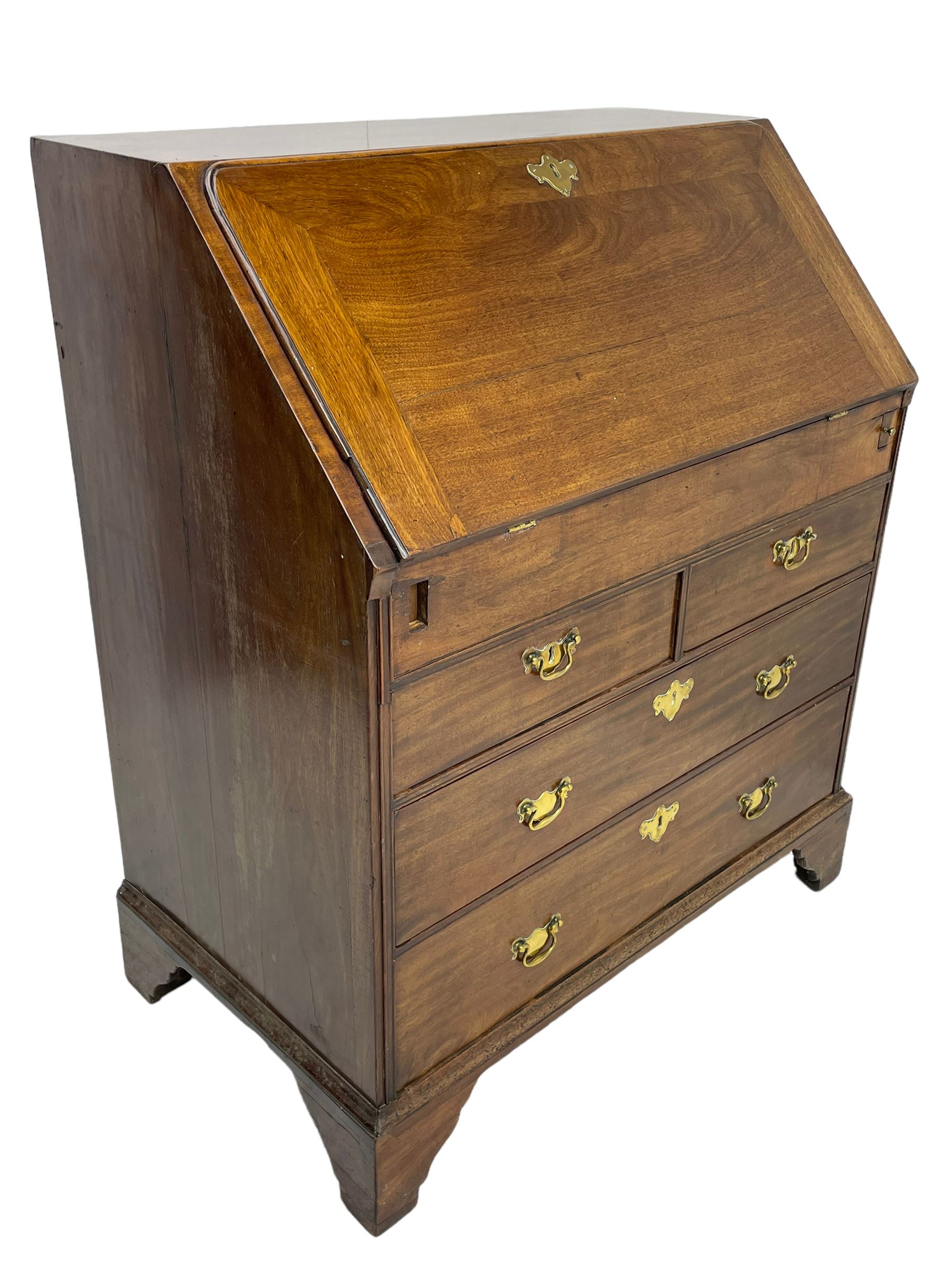 Georgian red walnut and mahogany bureau, moulded rectangular fall front with rounded upper corners, the interior fitted with sliding storage well, a combination of small drawers and pigeons holes, two short and two long drawers below, on bracket feet