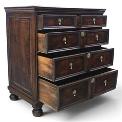 Late 17th century moulded front oak chest of drawers, rectangular plank top. above two banks of four graduated drawers, central escutcheons and drop handles, on squat bun feet