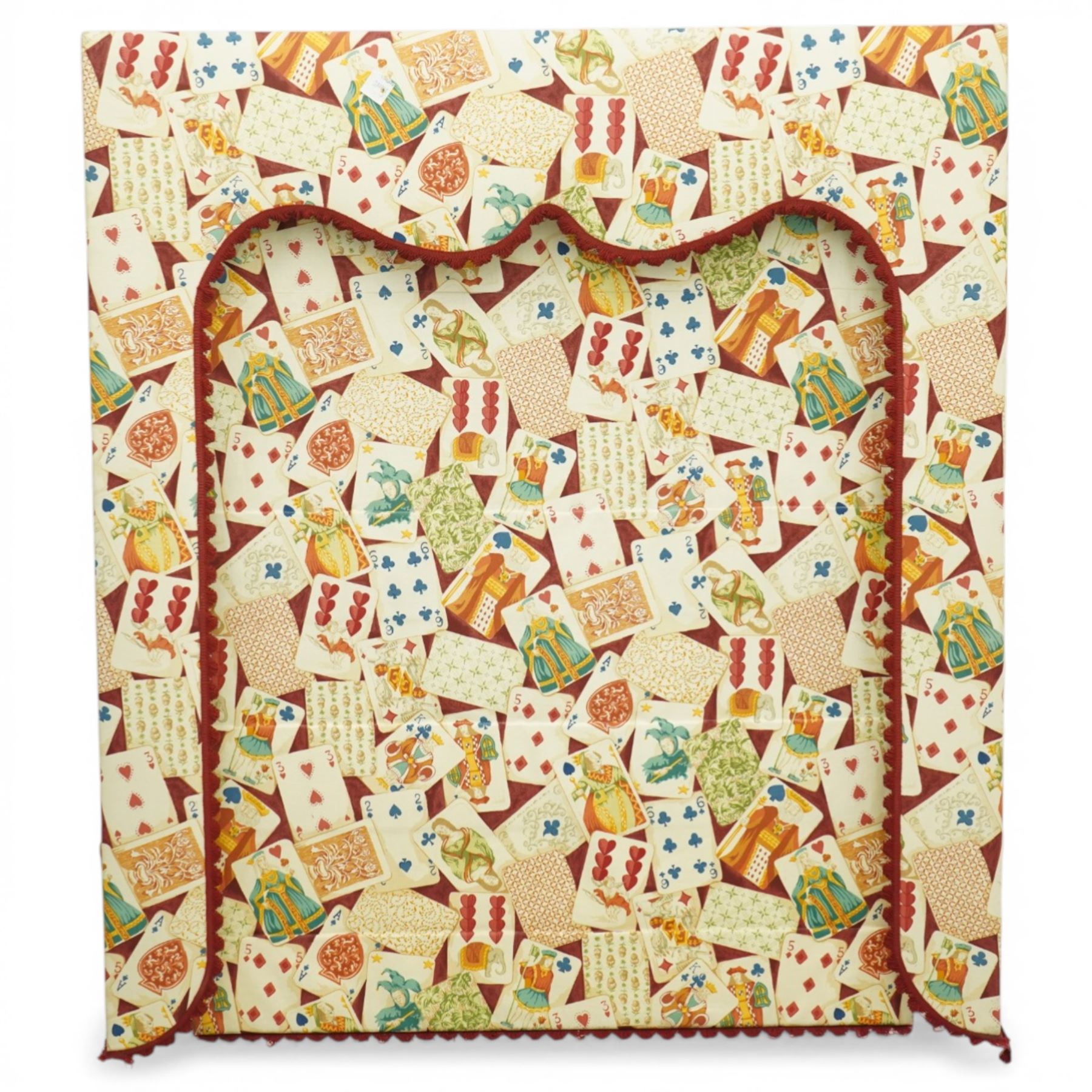 Late 20th century upholstered window pelmet with internal blind and side drapes, covered in a playing card patterned fabric with scalloped edging and red braid trim
