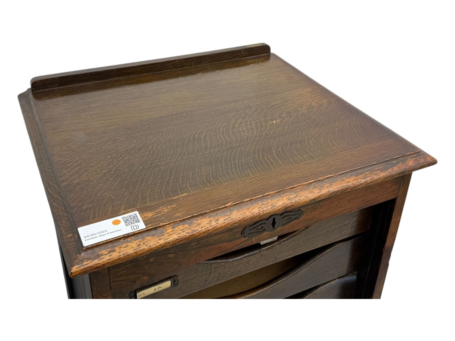 Two early 20th century mahogany tambour cabinets, each with retractable roll-top front revealing fitted interior with concave-front filing drawers and brass fittings
