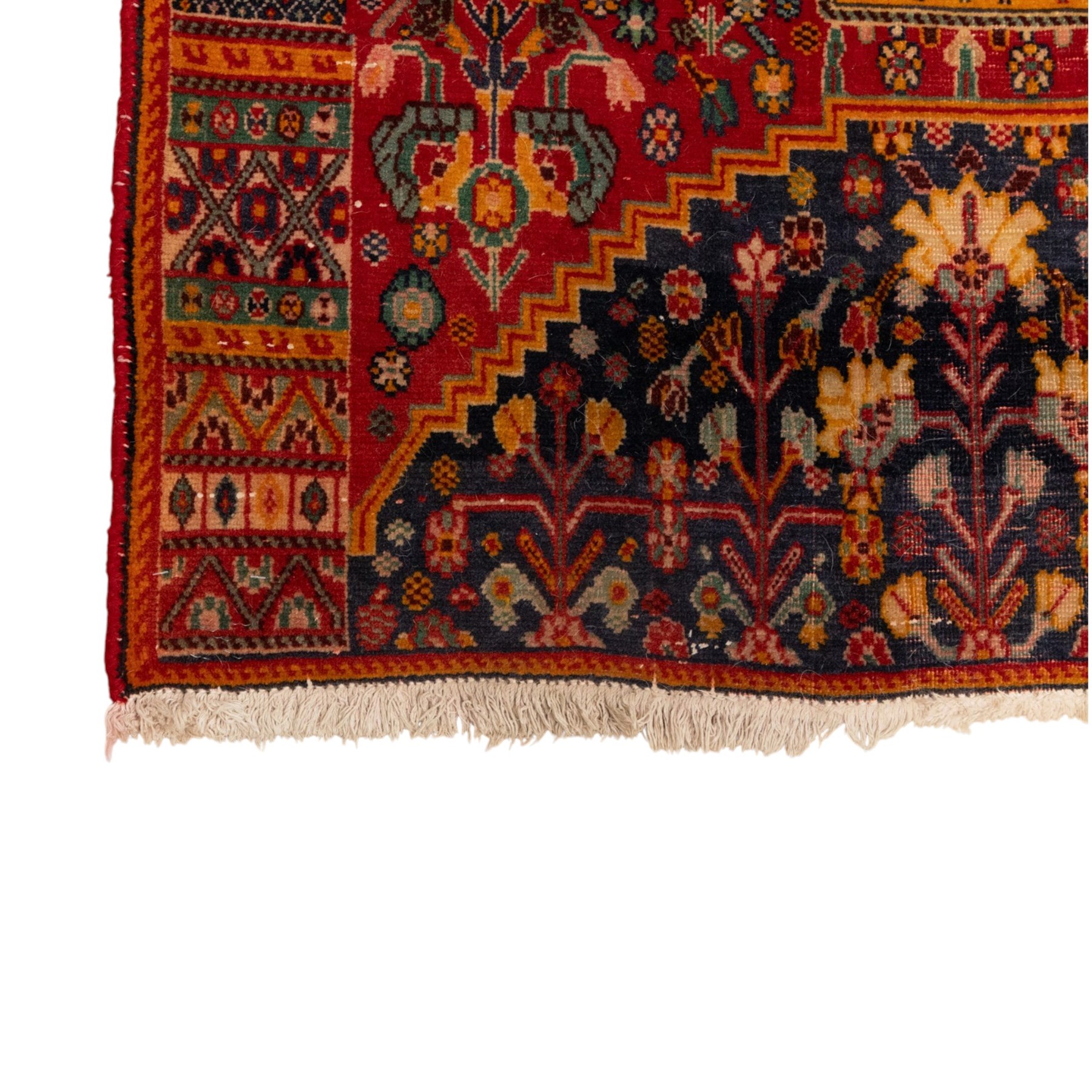 North Persian crimson ground rug, the field densely decorated with stylised flowering plants, urns and polychrome rosettes, within a stepped ochre outline, dark ground floral spandrels and geometric side panels