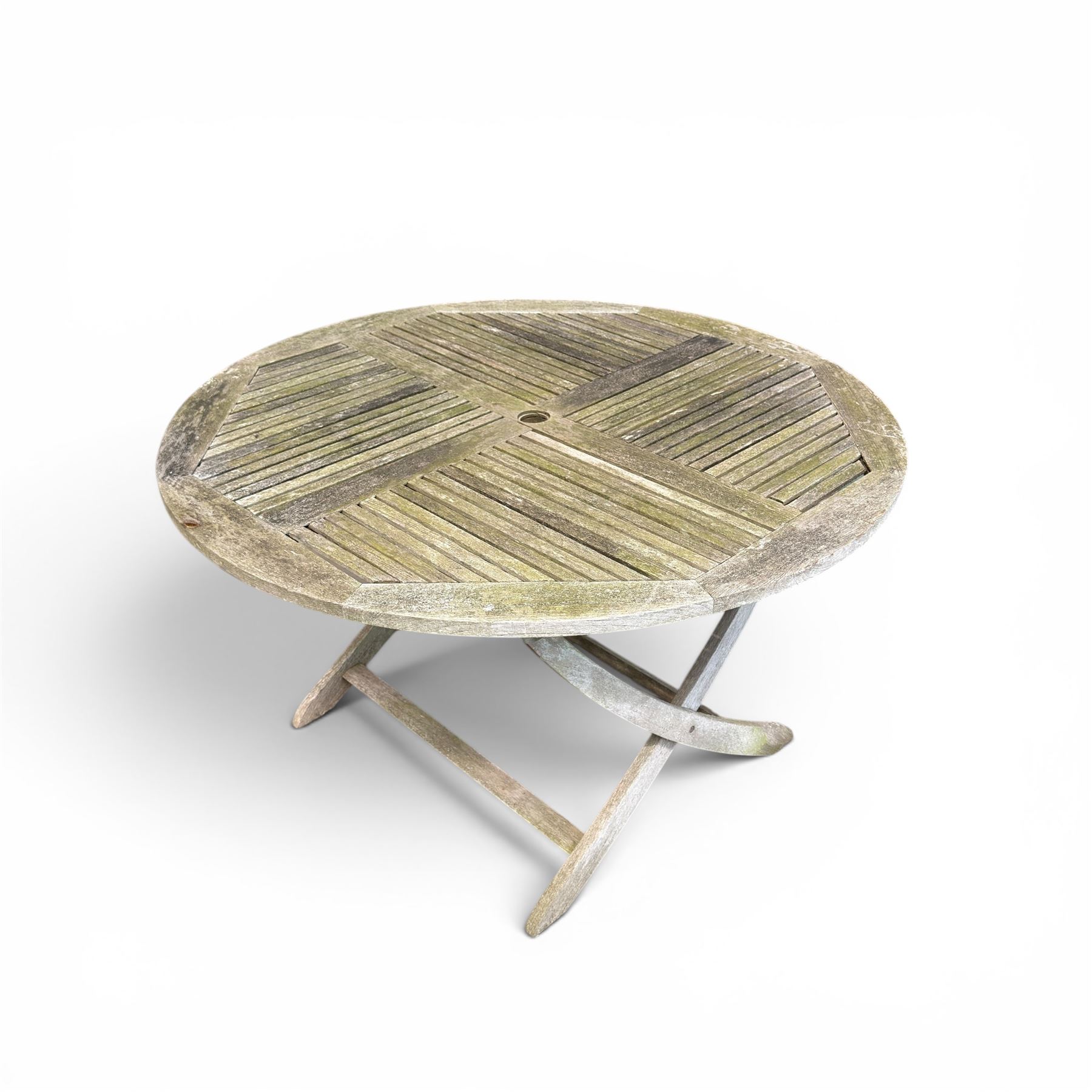 Five piece teak garden dining set, comprising circular folding table and four folding armchairs, with slatted seats and backs in a weathered finish
