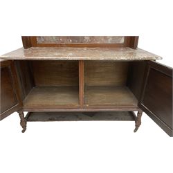 Late Victorian walnut washstand, raised back with carved pediment over bevelled mirror and marble panels, rectangular marble top, fitted with two figured panel doors, on turned supports