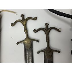 Near pair of short swords each with slightly curving 41cm fullered steel blade and all brass H-shaped hilt L52cm overall; plaited black leather whip; and reproduction pair of brass hilted swords, brass halberd blade and mace (7)