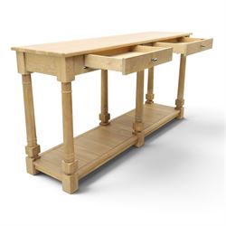 Neptune - 'Edinburgh' limed oak console table, with two
soft close drawers raised on ring-turned column supports,
with a pot shelf raised on square feet