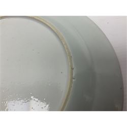 Three 18th century Chinese Famille Rose plates, the first example enamelled with blossoming peonies, rockwork and fence, the other two examples of similar design, decorated with blossoming peonies and sprigs within shaped inner borders, each approximately D23cm