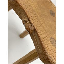 'Mouseman' oak three legged stool with dished kidney shaped seat, tapered octagonal supports, with carved mouse signature, by Robert Thompson of Kilburn 