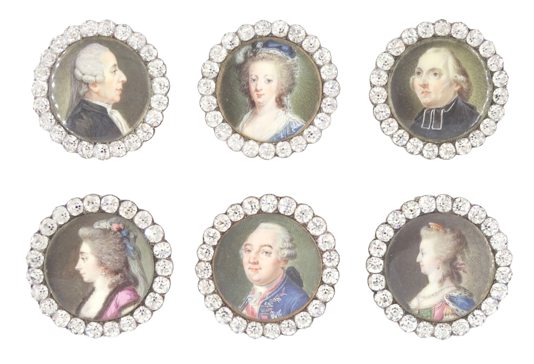 Set of six late 18th century French portrait miniature buttons, each finely painted upon ivory with a likeness of notable figures of the French Royal Court, set under glazed panels within silver frames mounted with paste stones, engraved verso with the sitters’ names and fitted with eyelets, later adapted with suspension rings; comprising “LE ROY” (Louis XVI), “LA REINE” (Marie Antoinette, youth portrait), “LA REINE” (Marie Antoinette, mature portrait), “MADAME” (Maria Josepha of Savoy, 1771–1810, wife of Louis, Comte de Provence, later King Louis XVIII), “M. BAILLY” (Jean Sylvain Bailly, 1736–1793, Mayor of Paris), and “M. L’ABBÉ MAURY” (Jean-Siffrein Maury, 1746–1817, Cardinal and Archbishop of Paris), overall D3.5cm. This lot has been registered for sale under Section 10 of the APHA Ivory Act