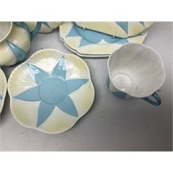 Shelley Dainty pattern tea wares, of lobed form with blue star decoration on merging white and yellow ground, comprising five teacups, five saucers, six tea plates, milk jug and cake plate, all with printed green mark beneath, some with painted pattern no 11770
