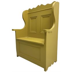 Early 20th century painted pine settle hall bench, shaped cresting rail over panelled back, hinged box seat, in mustard yellow finish