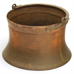 19th century brass and copper cauldron, circular open body with rolled rim, riveted side mounts and swing carrying handle, on broad flared circular foot