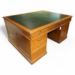 Late 19th century twin pedestal oak partner's desk, rectangular top with inset green leath...