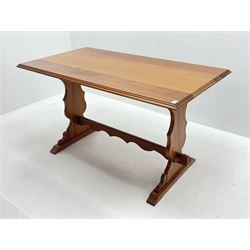 Late 20th century teak table, moulded rectangular top on shaped end supports joined by pegged stretcher, sledge supports